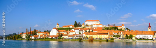 Scenic panoramic view of river Drava and castle on hill in old historic touristic town Ptuj in Slovenia photo