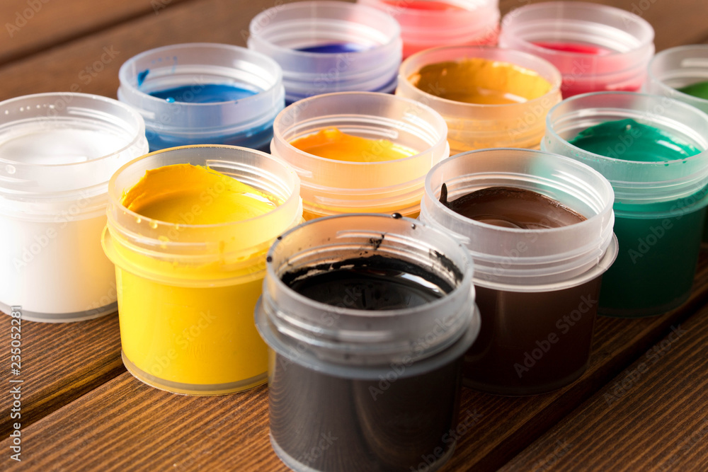 Various paints on the old wooden table . Creative concept Various paints on the old wooden table . Creative concept