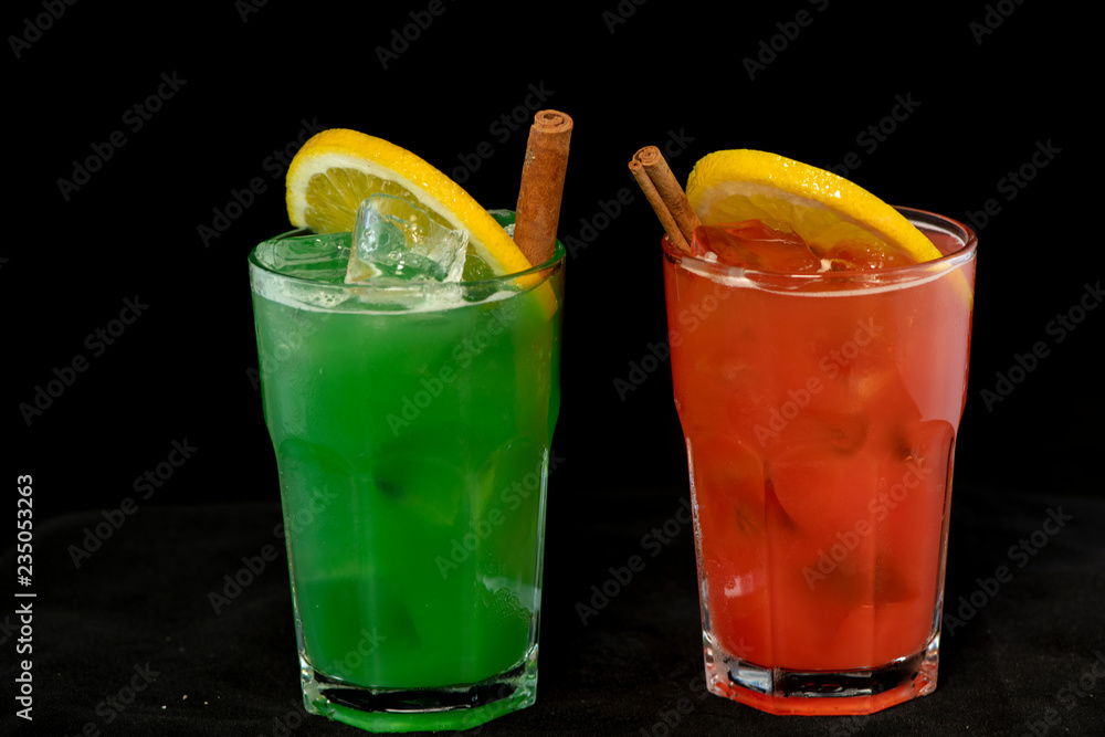 Red and Green Cocktails with red and green juices, alcohol and lime wedge Red and Green Cocktails with red and green juices, alcohol and lime wedge