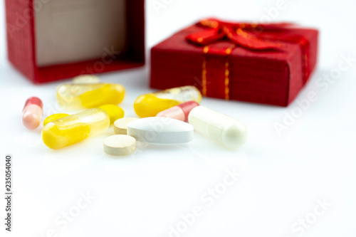medicines and gift box isolated on white. Christmas sickness concept. 