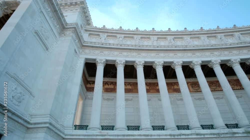 Low angle pan right from upper level of the column facade of Il Vittoriano or Altar of the Fatherland national monument in Rome, Italy. 4K UHD at 29.97fps Low angle pan right from upper level of the column facade of Il Vittoriano or Altar of the Fatherland national monument in Rome, Italy. 4K UHD at 29.97fps
