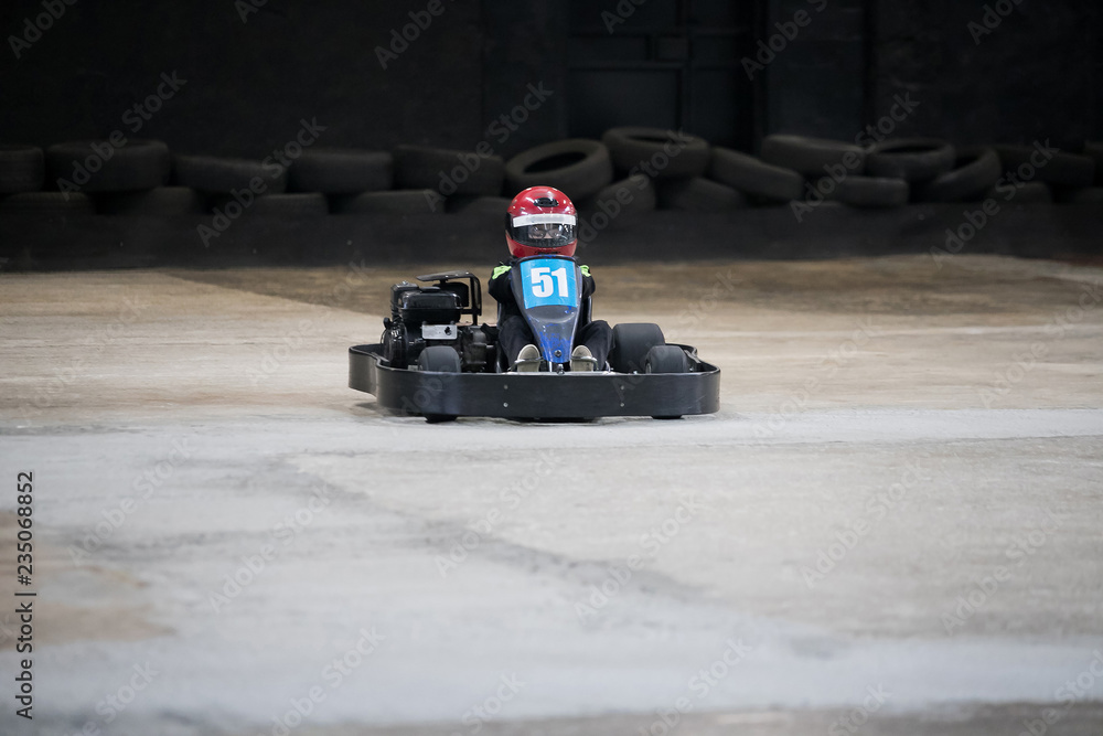 The man is going on the go-kart on karting track