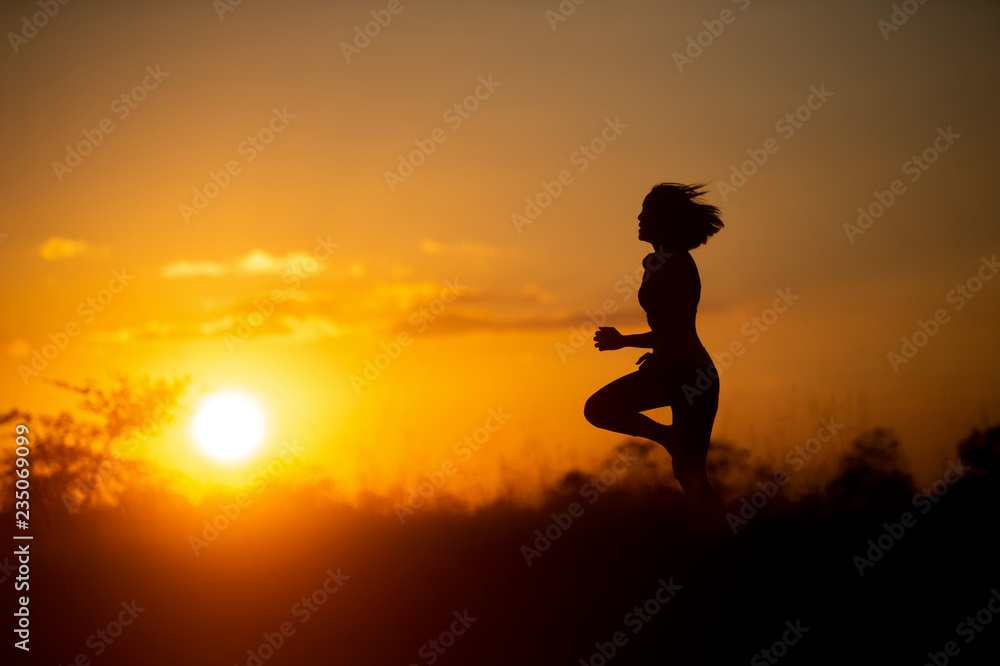 woman runner running with sunset background