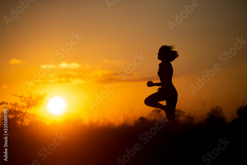 woman runner running with sunset background