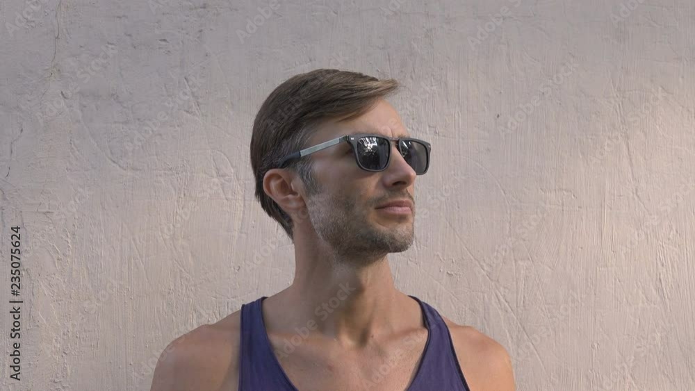 man in sunglasses against the wall. man in sunglasses against the wall.
