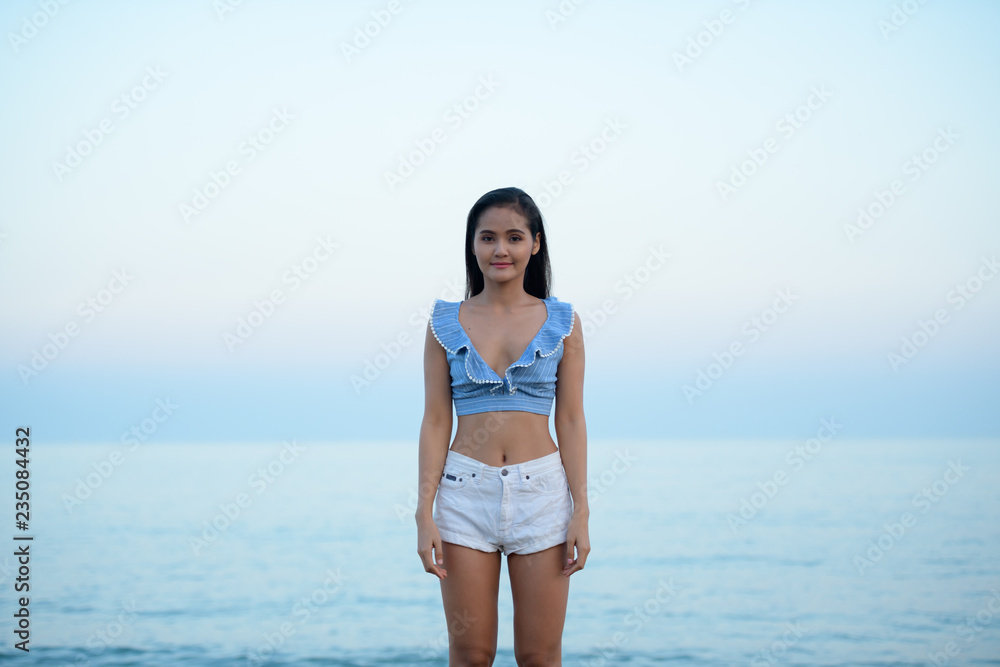 Young Beautiful Asian Tourist Woman Standing By The Beach Young Beautiful Asian Tourist Woman Standing By The Beach
