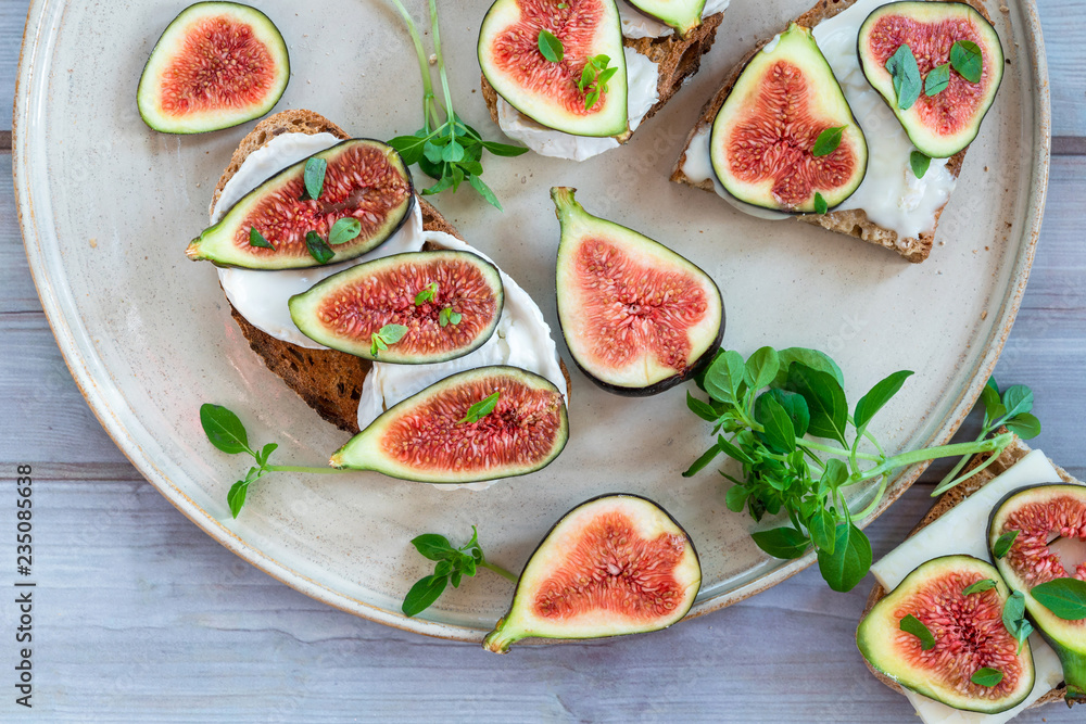 Goat cheese and figs on toast - healthy lunch idea - top view Goat cheese and figs on toast - healthy lunch idea - top view