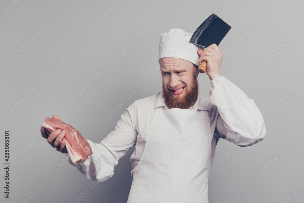 Portrait of attractive handsome butcher guy holding fresh meat a Portrait of attractive handsome butcher guy holding fresh meat a