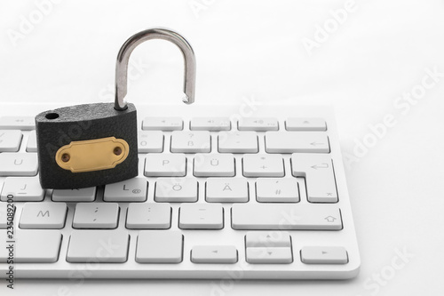 Open padlock on white keyboard