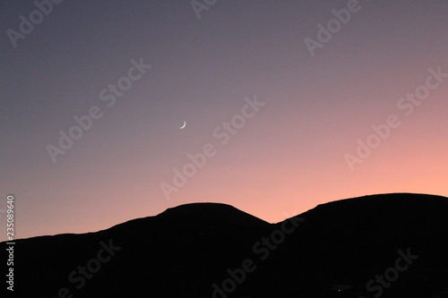 moon and sunset in mountains