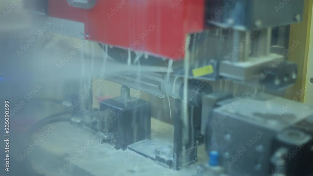Jets of cooling liquid on metal production. Automated production line at factory Jets of cooling liquid on metal production. Automated production line at factory