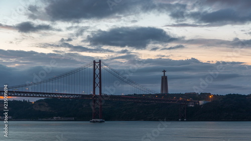Fototapeta Naklejka Na Ścianę i Meble -  Lisbon city before sunrise with April 25 bridge night to day timelapse