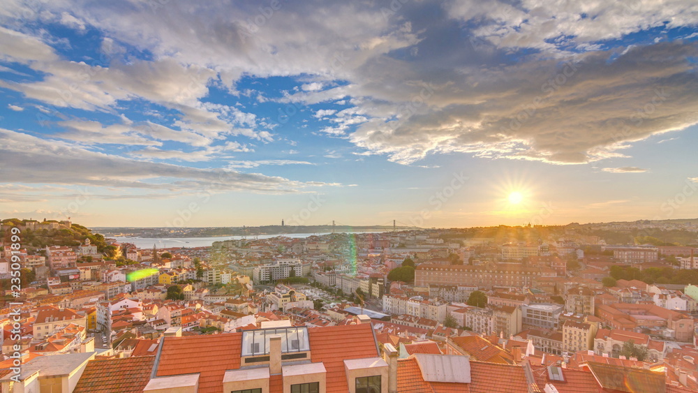 Lisbon at sunset aerial panorama view of city centre with red roofs at Autumn evening timelapse, Portugal