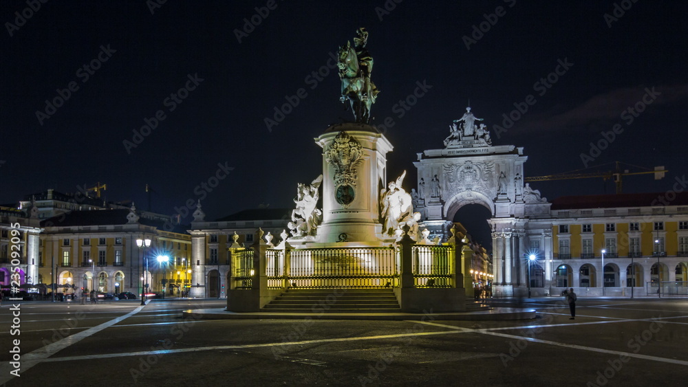 Triumphal arch at Rua Augusta and bronze statue of King Jose I at Commerce square night timelapse hyperlapse in Lisbon, Portugal.