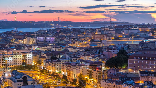 Lisbon after sunset aerial panorama view of city centre with red roofs at Autumn day to night timelapse, Portugal © neiezhmakov