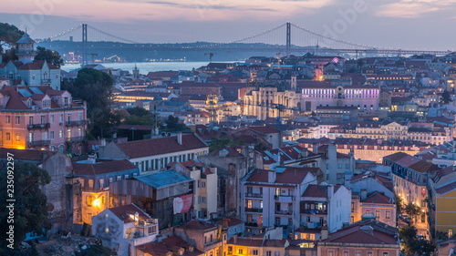 Lisbon after sunset aerial panorama view of city centre with red roofs at Autumn day to night timelapse  Portugal