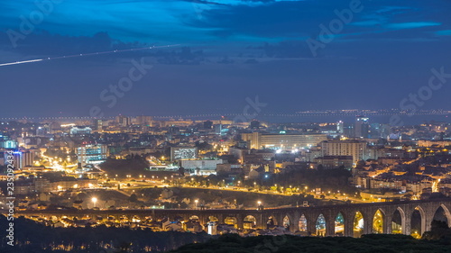 Panoramic View over Lisbon and Almada from a viewpoint in Monsanto night to day timelapse.