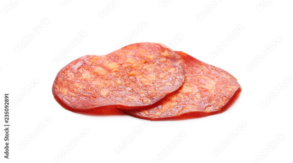Obraz premium Spicy salami sausage slices isolated on white background