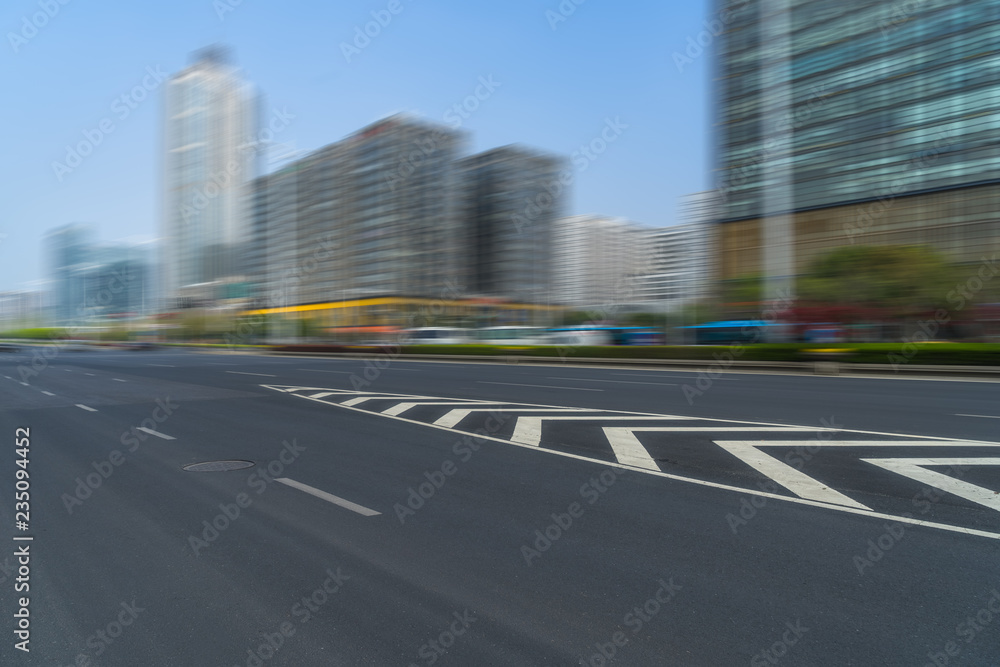 Fototapeta premium city empty traffic road with cityscape in background.