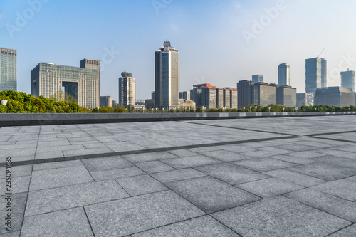 Panoramic skyline and buildings with empty square floor. © hallojulie