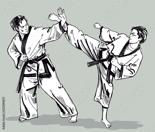 Two young men in kimonos training karate blows. Martial art