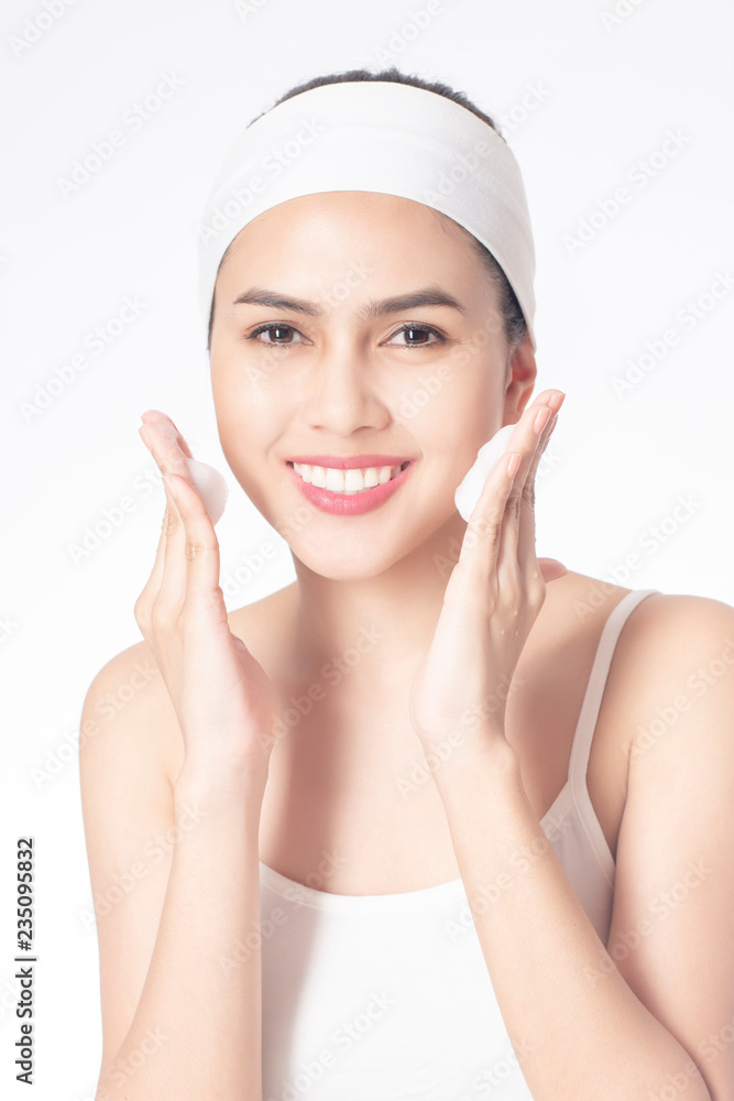 Beautiful woman is washing her face on white background Beautiful woman is washing her face on white background
