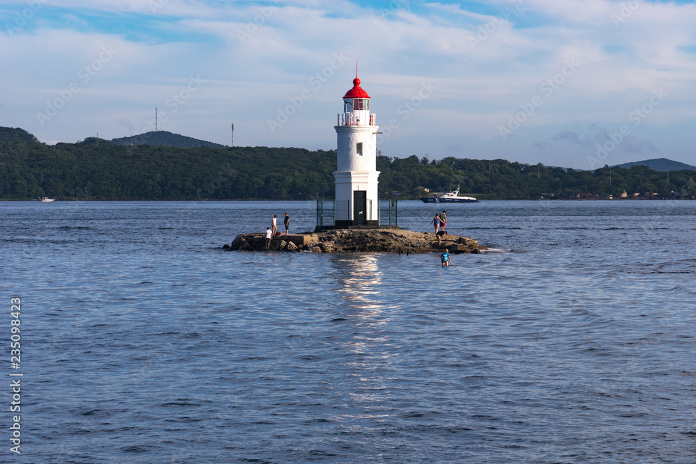 Seascape with a view of the lighthouse against the sea. Seascape with a view of the lighthouse against the sea.