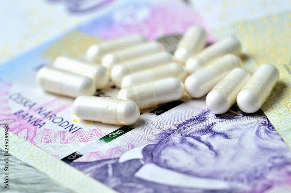 Pills on Czech banknotes - concept of healthcare and finance Pills on Czech banknotes - concept of healthcare and finance