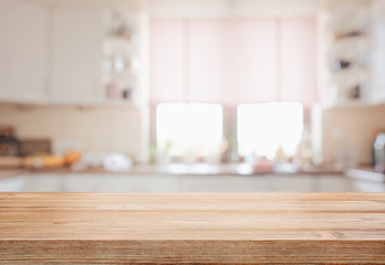 Empty tabletop over defocused kitchen with copy space