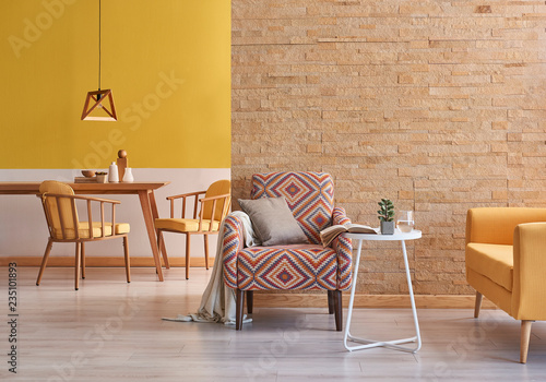 Obraz na plátně Yellow room wooden furniture and brick wall concept.