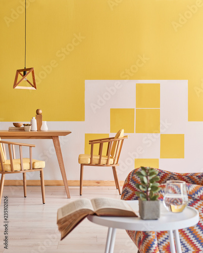 Close up coffee table and armchair decoration  yellow and white wall wooden furniture.