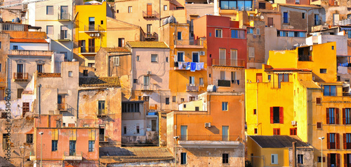 The colorful old houses with windows in city of Sciacca overlooking its harbour. Province of Agrigento, Sicily.