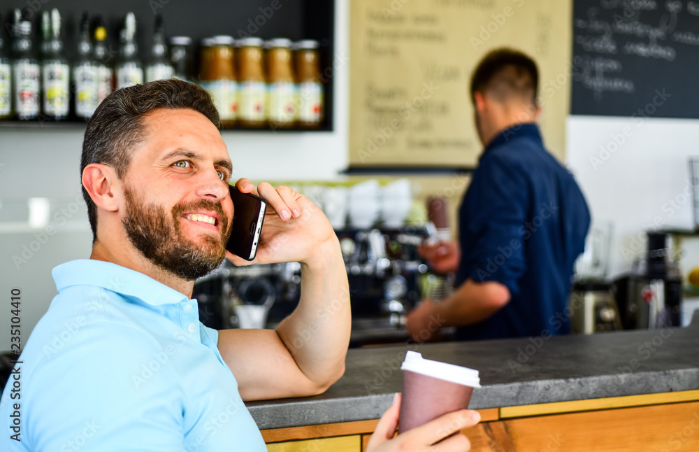 Coffee break concept. Glad to hear you. Coffee take away option for busy people. Man mobile conversation cafe barista background. Drink coffee while waiting. Man smartphone order coffee in cafe Coffee break concept. Glad to hear you. Coffee take away option for busy people. Man mobile conversation cafe barista background. Drink coffee while waiting. Man smartphone order coffee in cafe