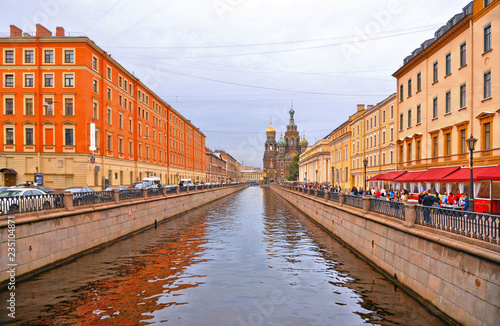City canal with old classic buildings and Church of the Savior on Spilled Blood in back ground in Saint Petersburg, Russia
