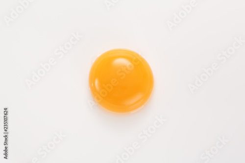 Raw egg yolk on a white background. View from above. photo