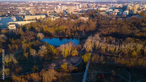 Aerial view of the autumn city park near the lake.
