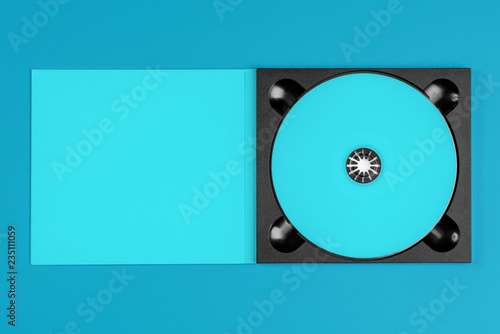 Pastel blue cd in case on pastel blue background.