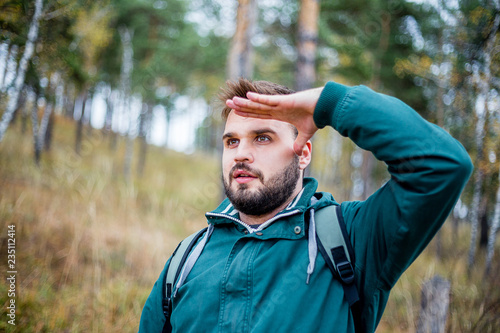 Fototapeta Naklejka Na Ścianę i Meble -  male hiker is looking at a distance