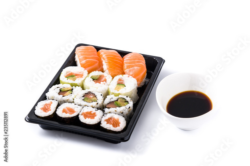 sushi assortment on black tray and soy sauce isolated on white background