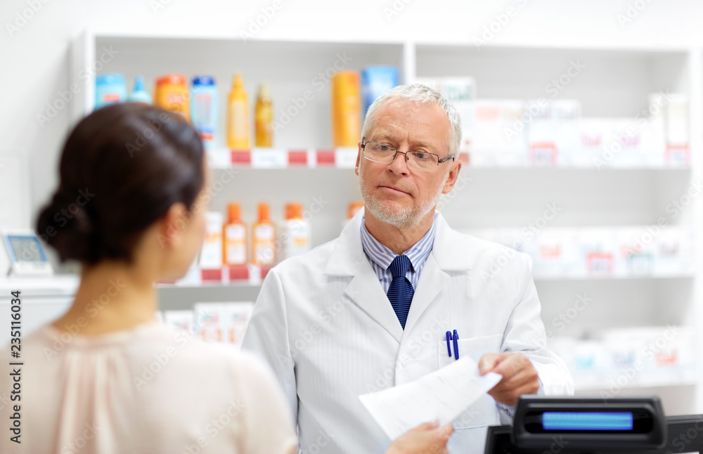 medicine, healthcare and people concept - senior apothecary taking prescription from customer at drugstore