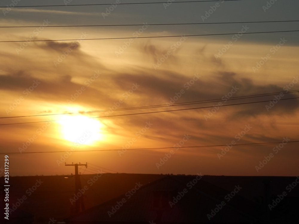 Naklejka premium Southern sunset above steppe with power lines.