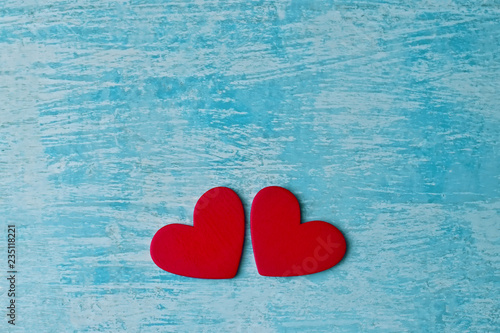 Couple wooden red hearts on rustic blue table background, Valentine's concept