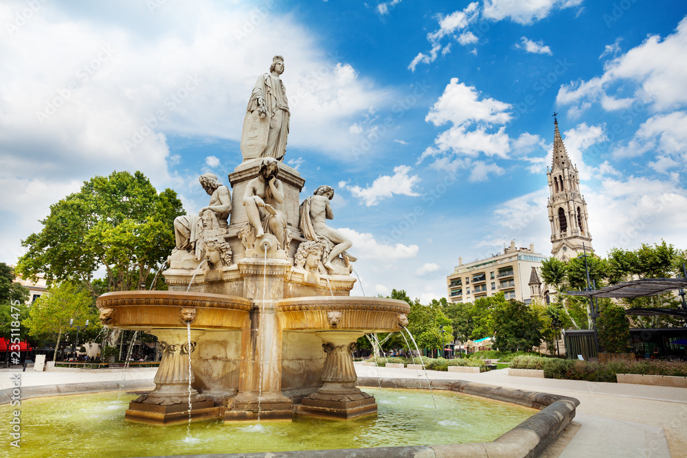 Fototapeta premium Fountain and Church of Sainte Perpetue in Nimes