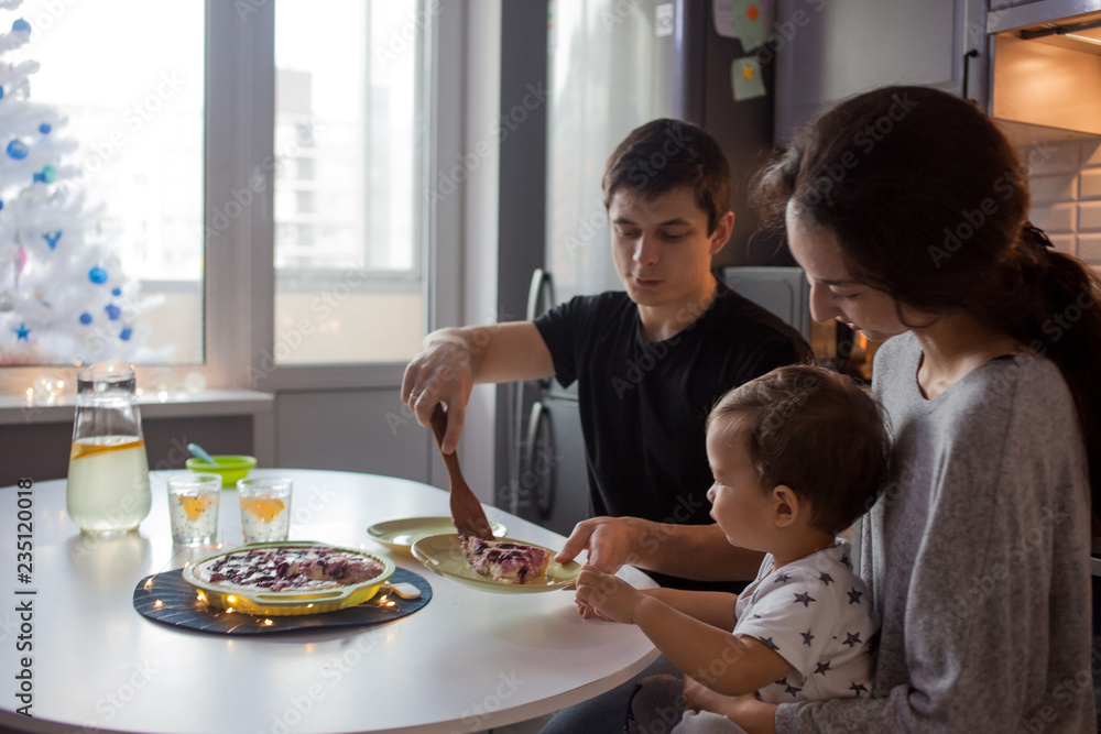 Family dinner, Father mom and baby at home in the kitchen. Family dinner, Father mom and baby at home in the kitchen.