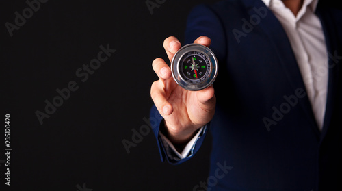 businessman holds compass in his hand © SZ Photos