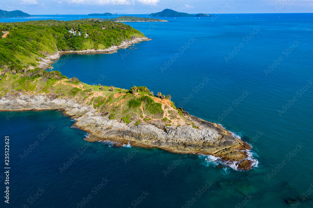 Aerial view of a rocky peninsula leading into a tropical oceal (Promthep Cape, Phuket)