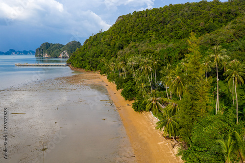 Aerial view of a small tropical beach surrounded by lush foliage and jungle (Koh Yao Noi, Thailand)