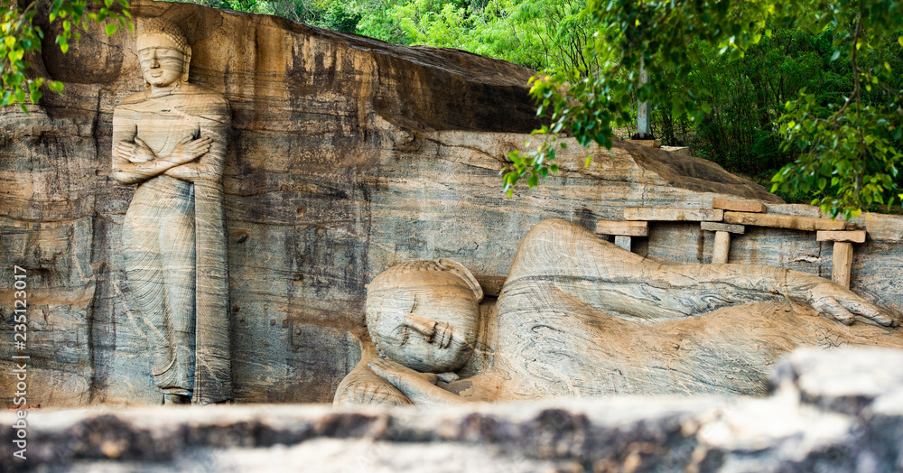 (selective focus) The beautiful statue of Reclining Buddha and Monk Ananda, Gal Viharaya, Polonnaruwa, Sri Lanka.