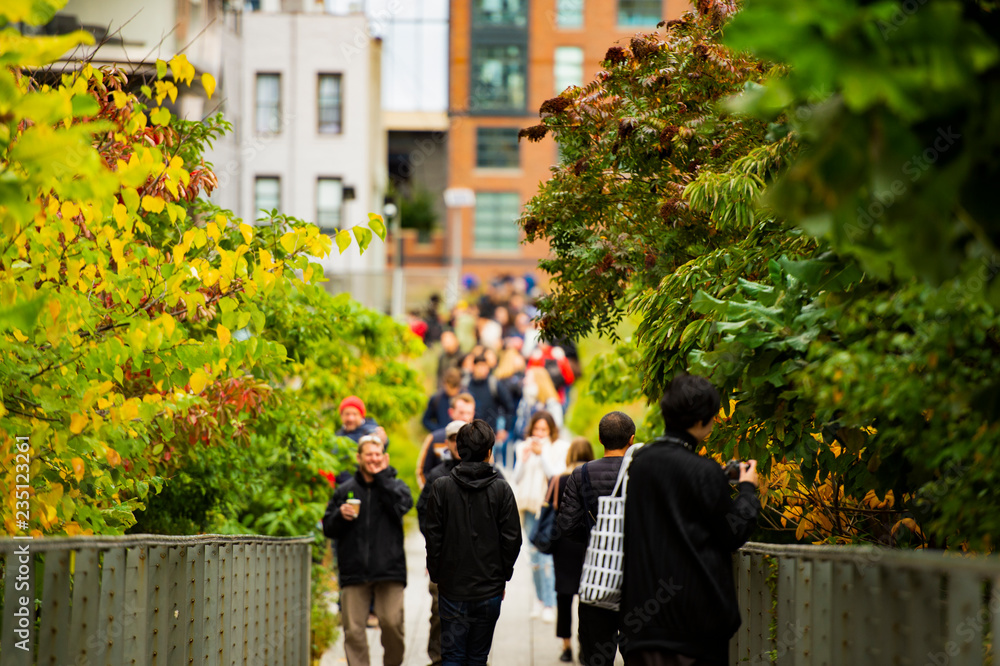 (selective focus) People walking on the beautiful High Line in Manhattan, New York, USA.
