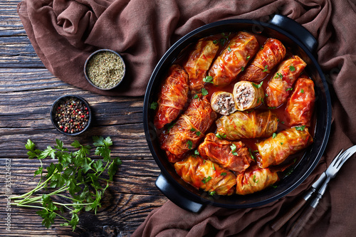 overhead view of raw cabbage leaves rolls